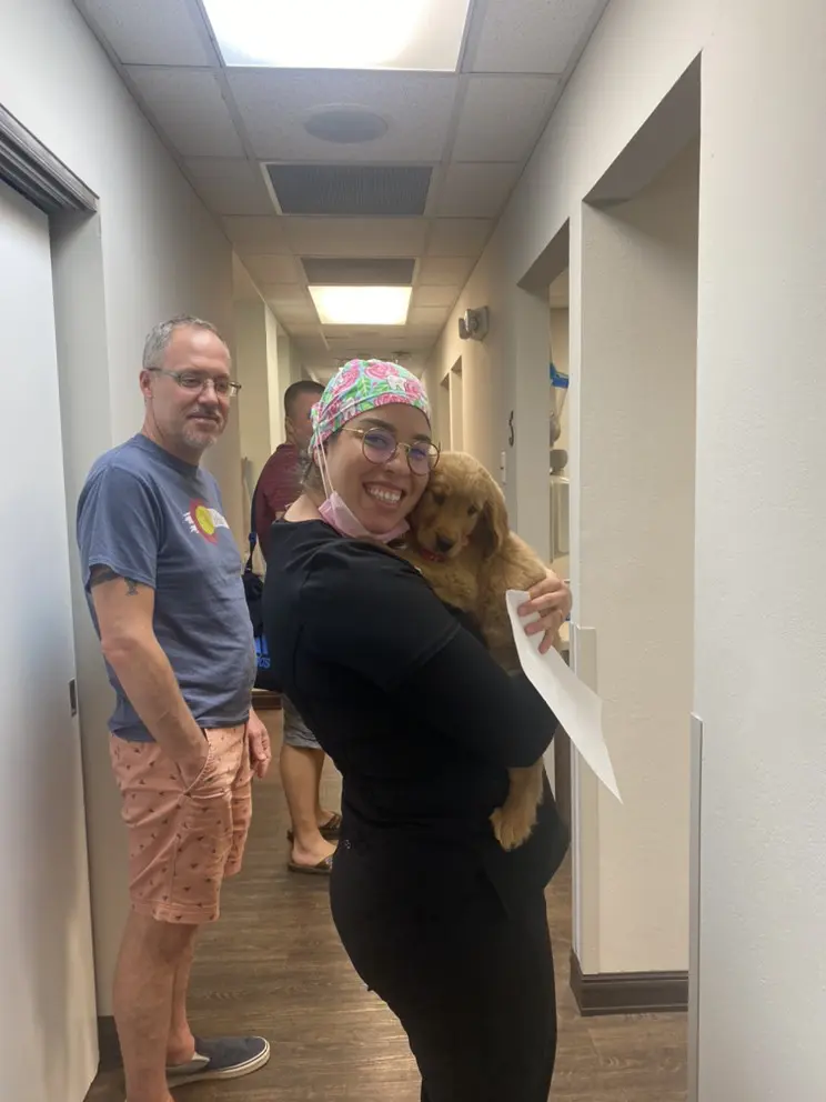 A group of people standing in a hallway.