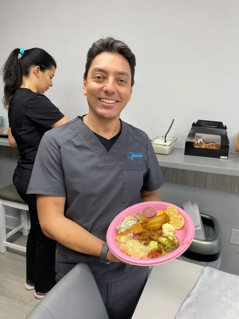 A man holding a plate of food in front of him.