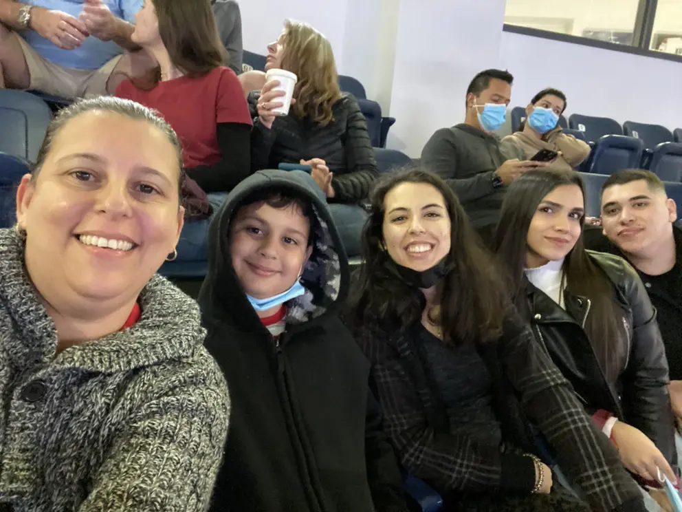 A group of people sitting in the stands at an event.