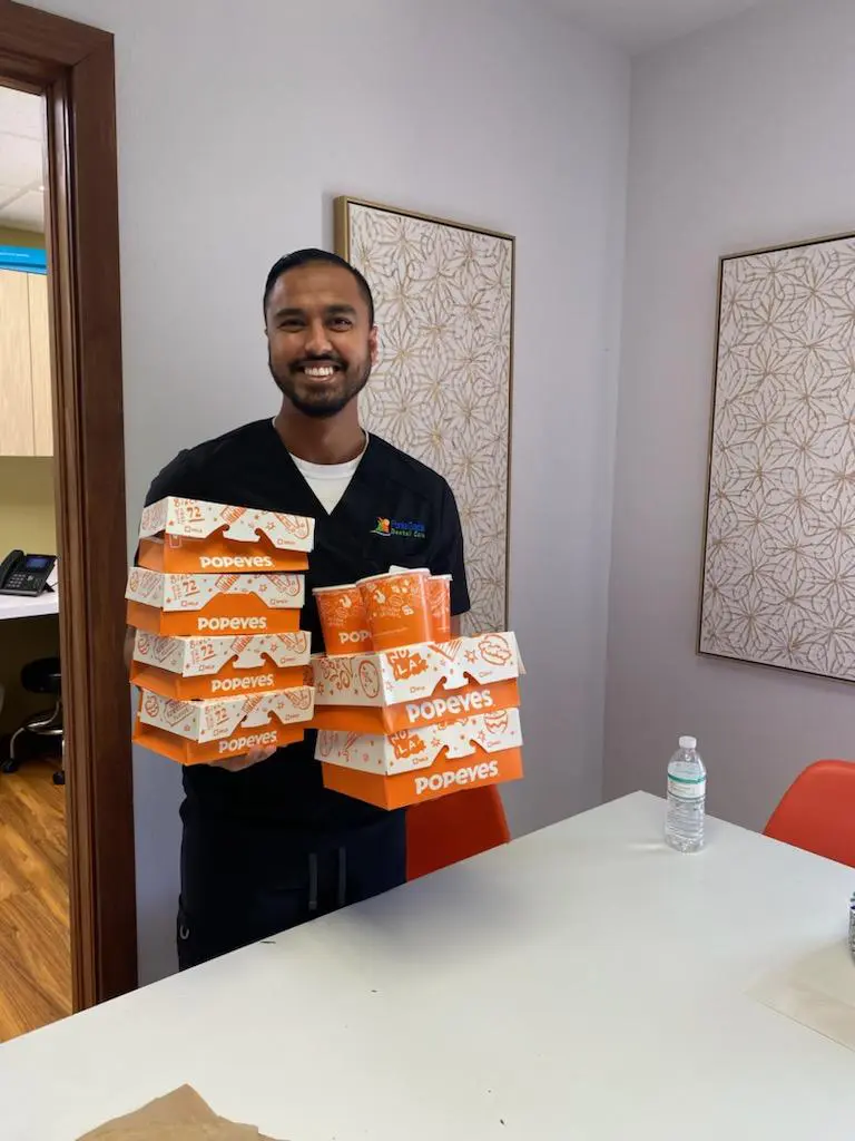 A man holding boxes of pizza in front of him.