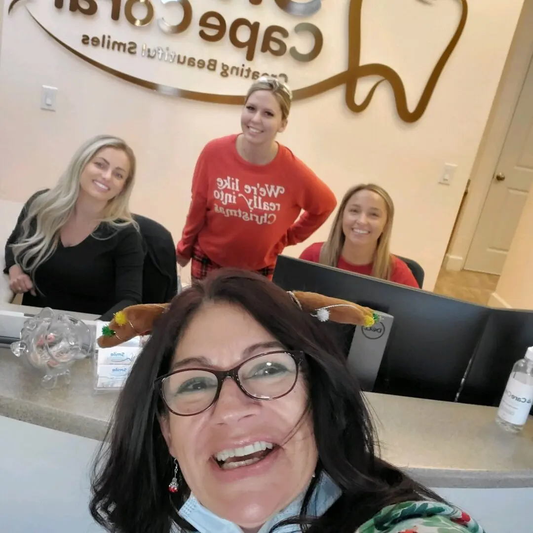 A group of people sitting at the counter in front of a sign.