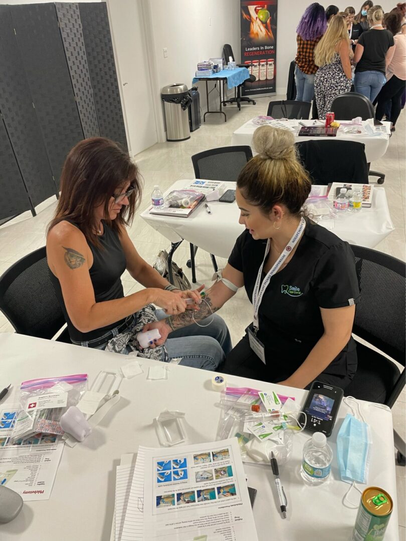 A woman is getting her nails painted at the salon.