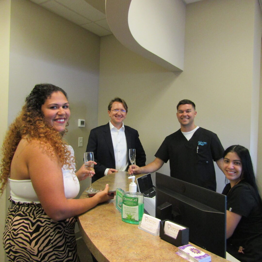 A group of people standing around a counter.