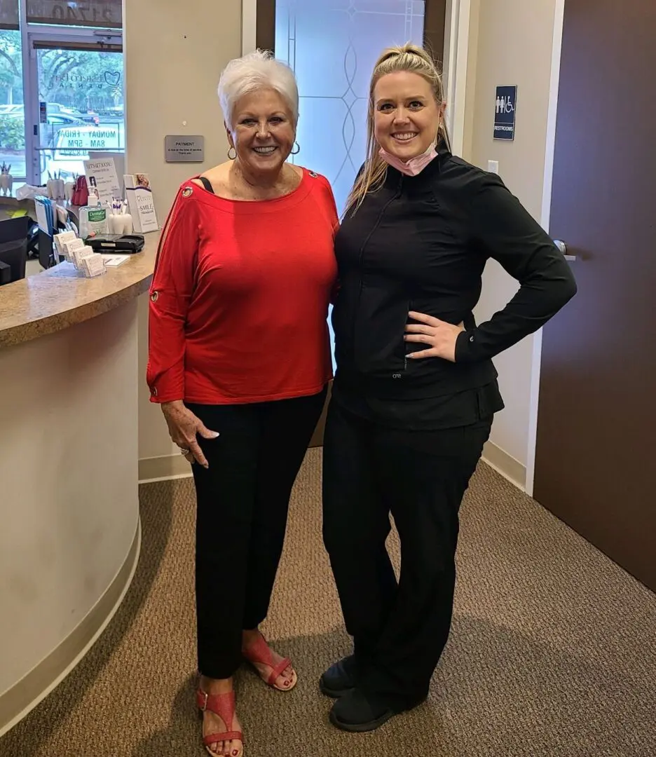 Two women standing next to each other in a room.