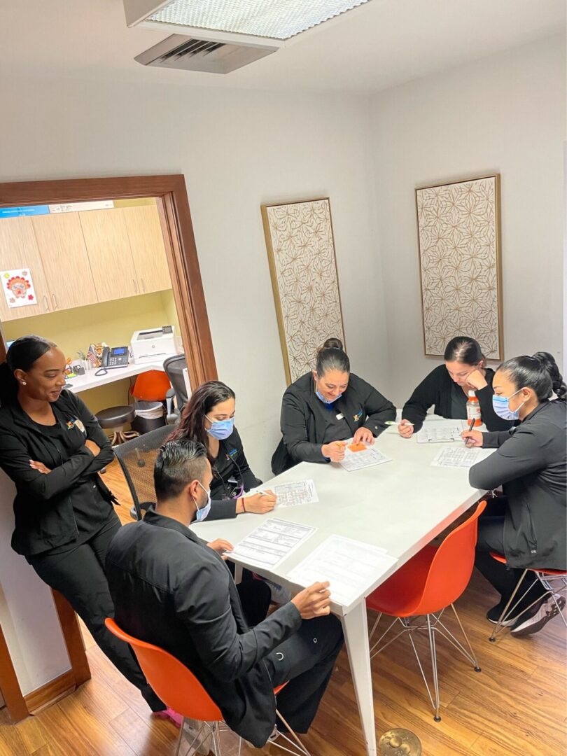 A group of people sitting around a table.