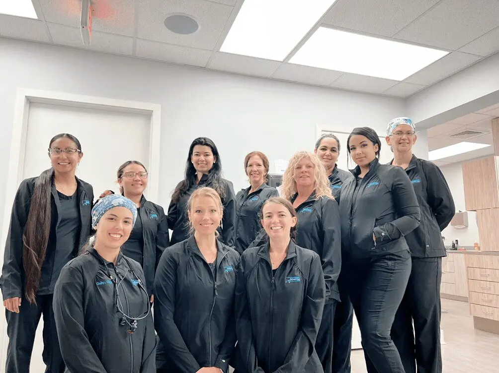 A group of women in black uniforms posing for a picture.