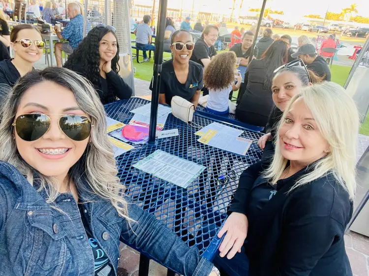 A group of women sitting at an outdoor table.