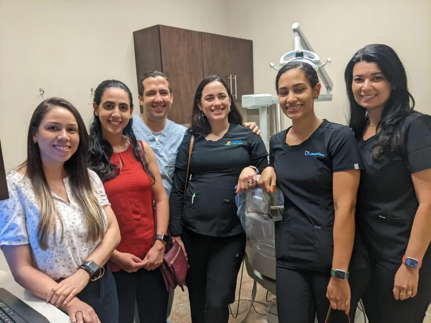 A group of people standing in front of an ultrasound machine.