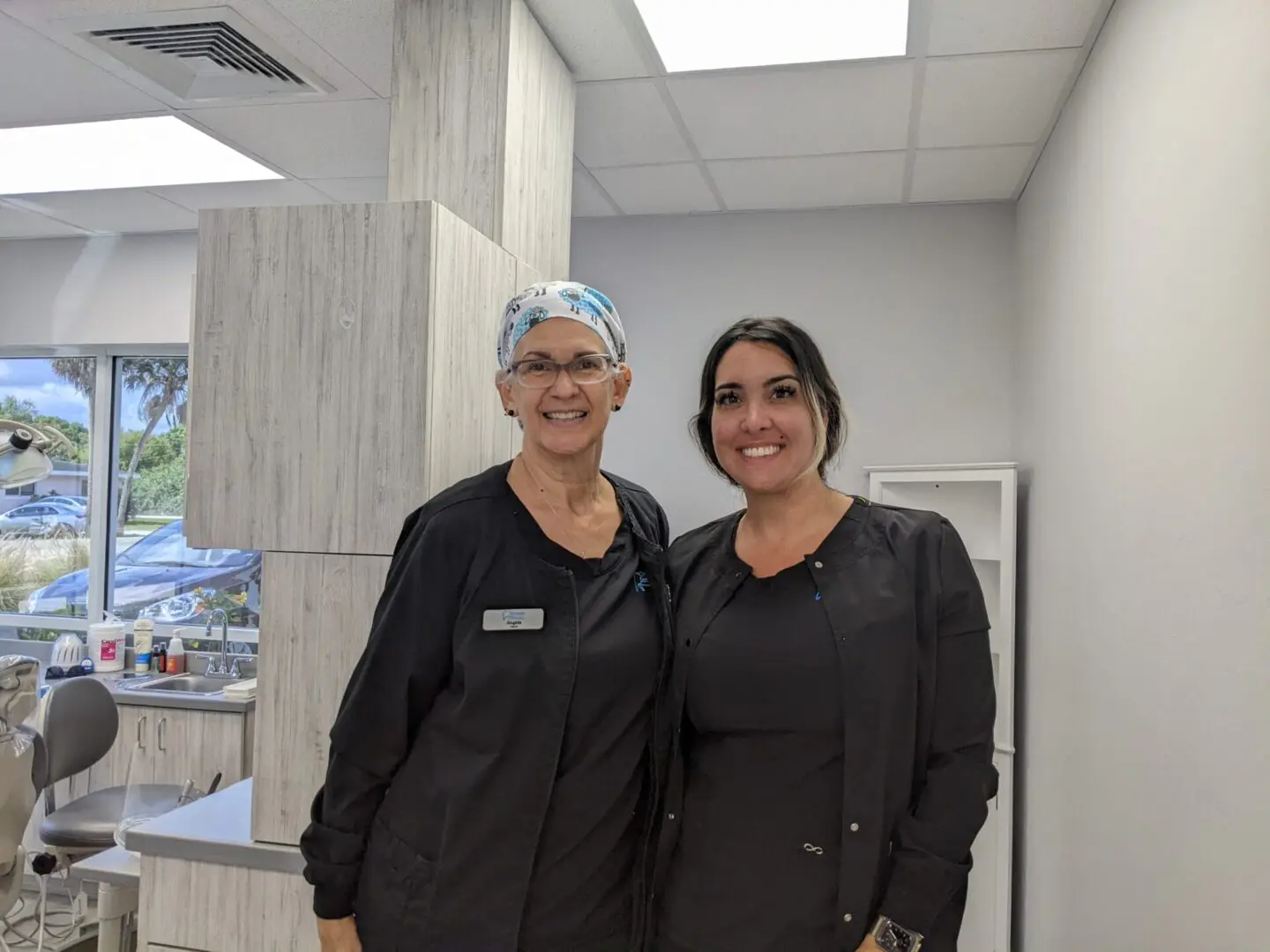 Two women standing next to each other in a room.