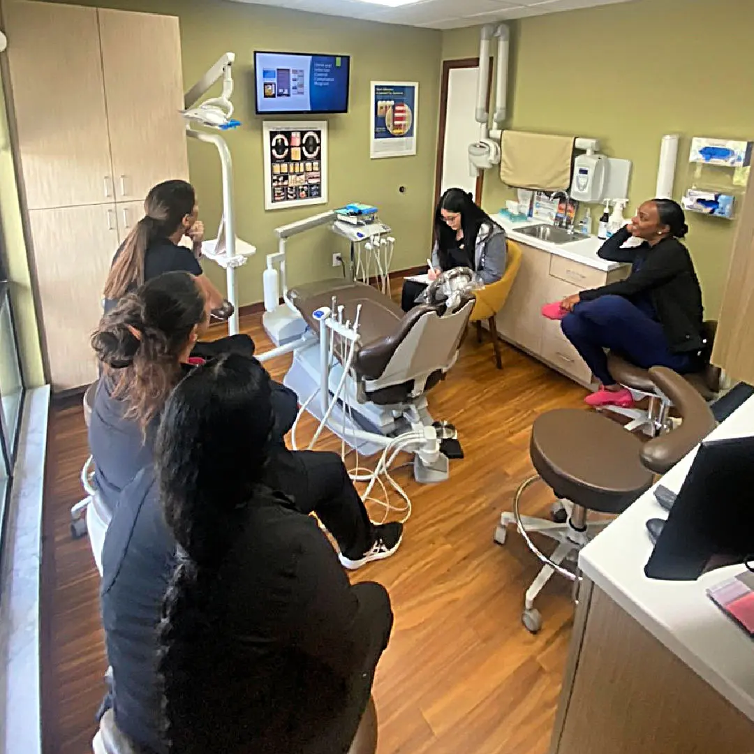 A group of people sitting in the dental office.