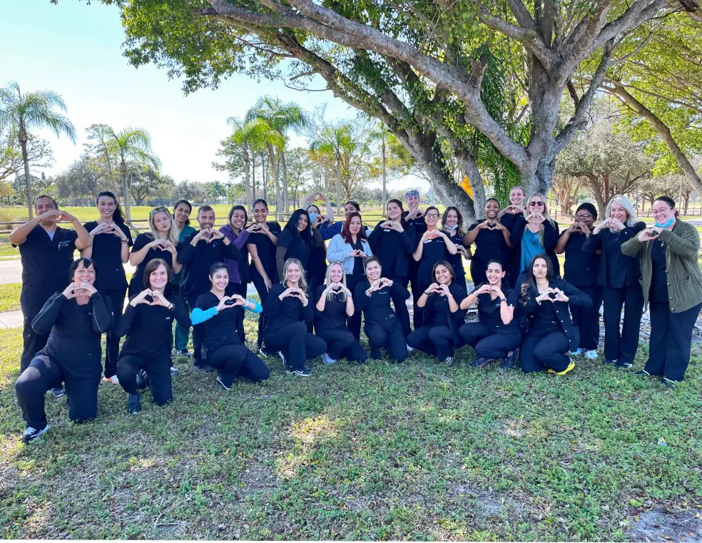 A group of people in black shirts and trees