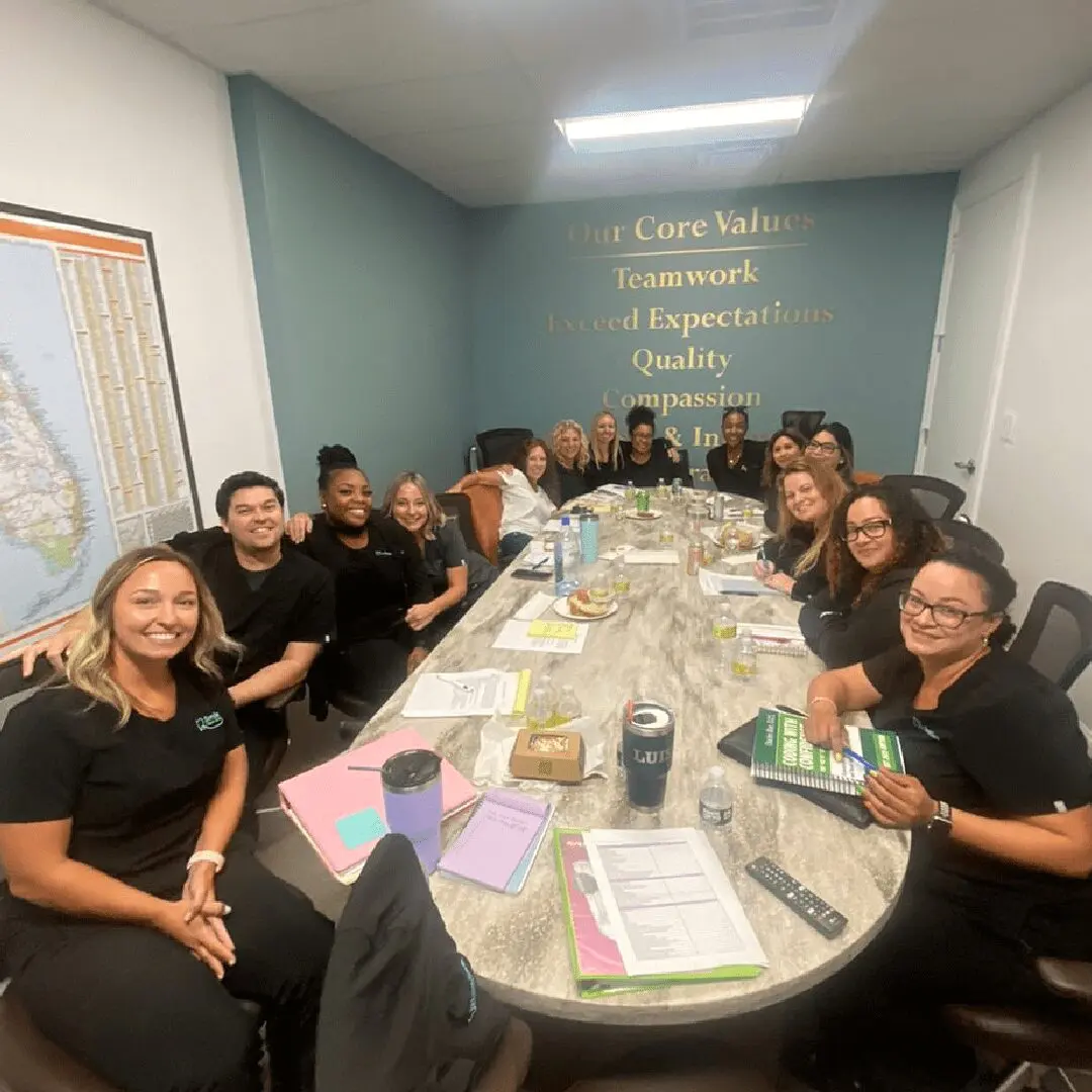 A group of people sitting around a table.