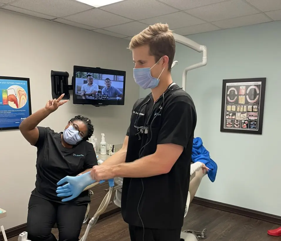 A dentist and his assistant wearing masks in the dental office.