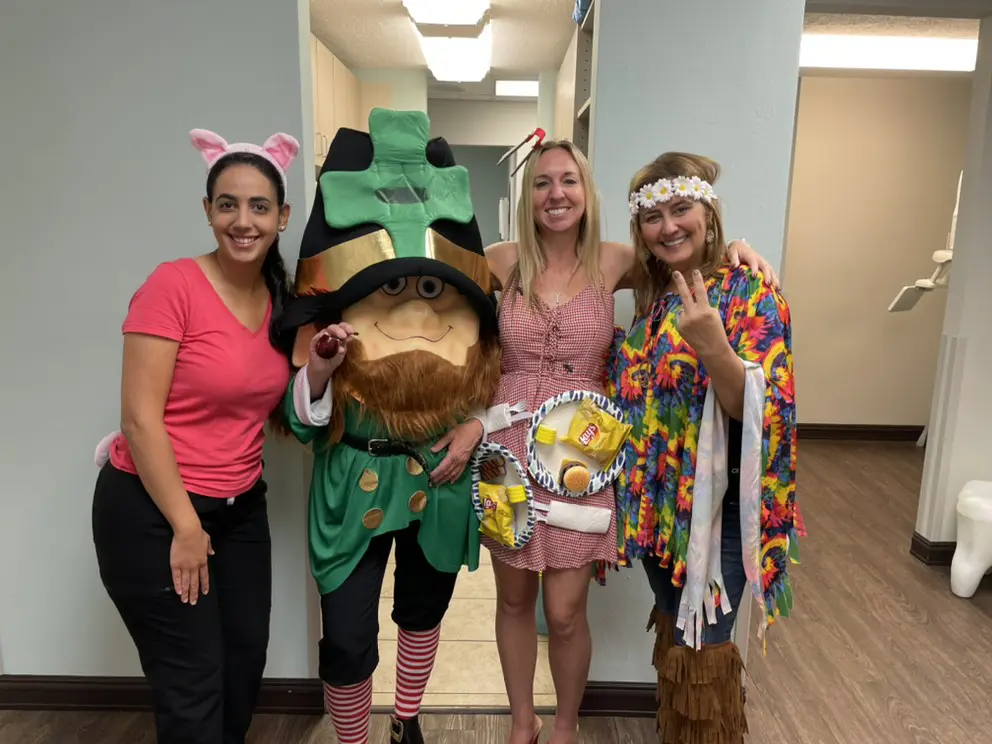 Three women and a man dressed as animals