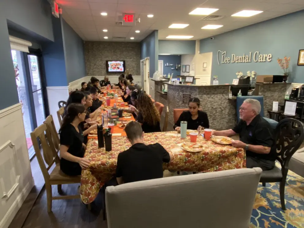 A group of people sitting at a table eating.