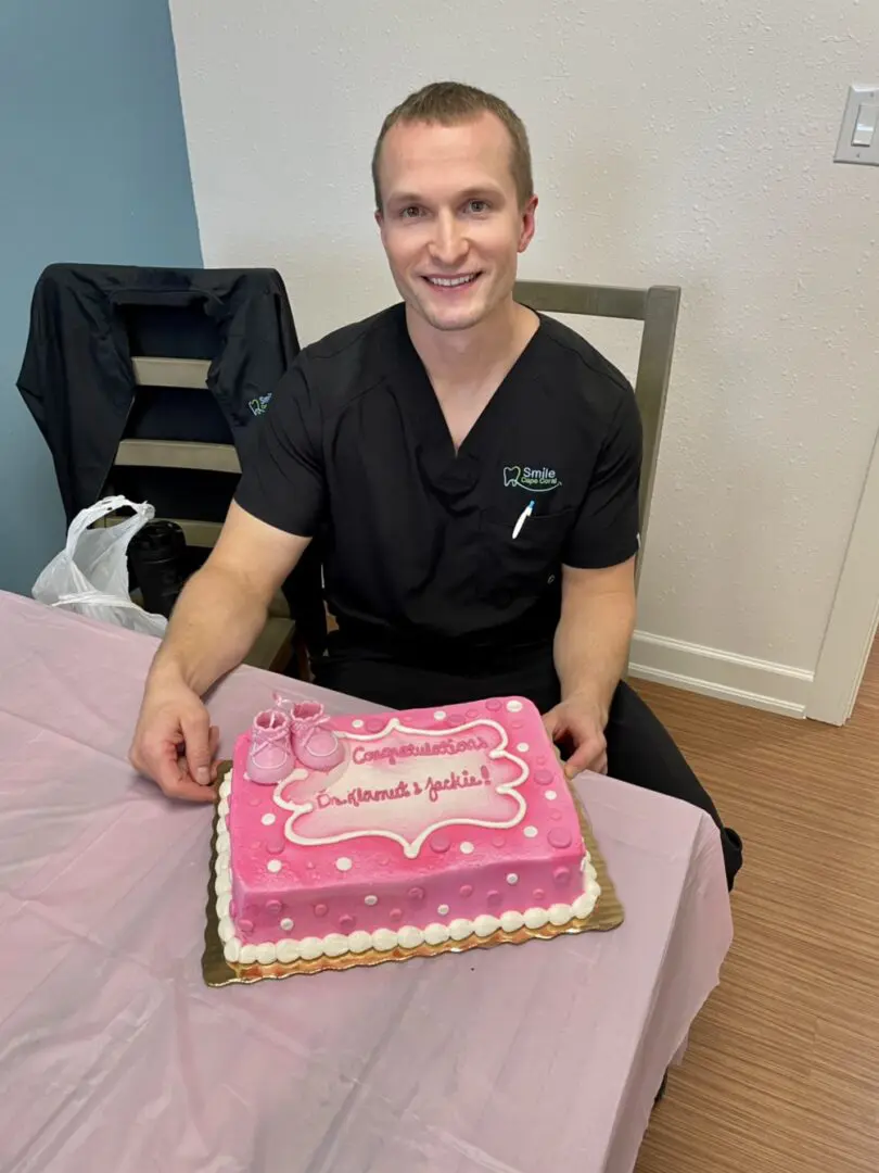 A man sitting at the table with a cake