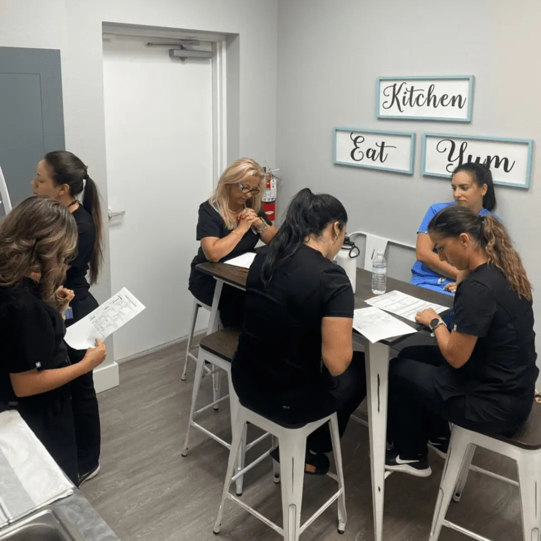 A group of women sitting at tables in a room.