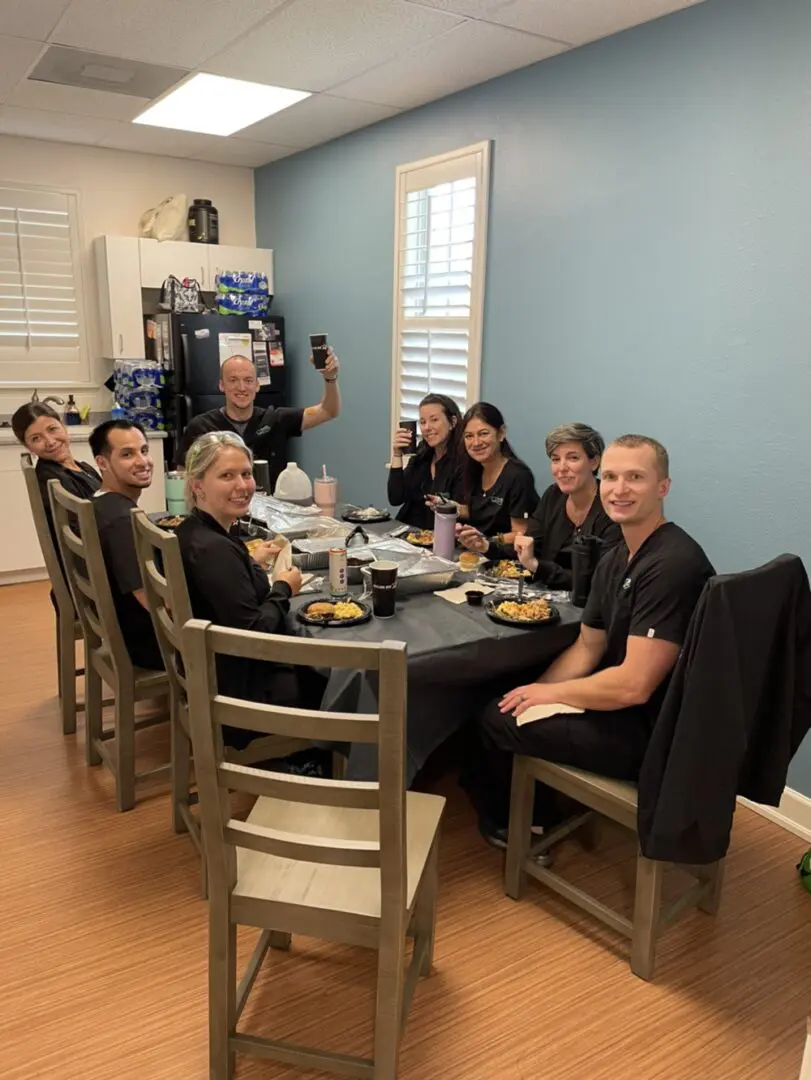 A group of people sitting at a table eating.