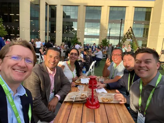 A group of people sitting at a table with food.