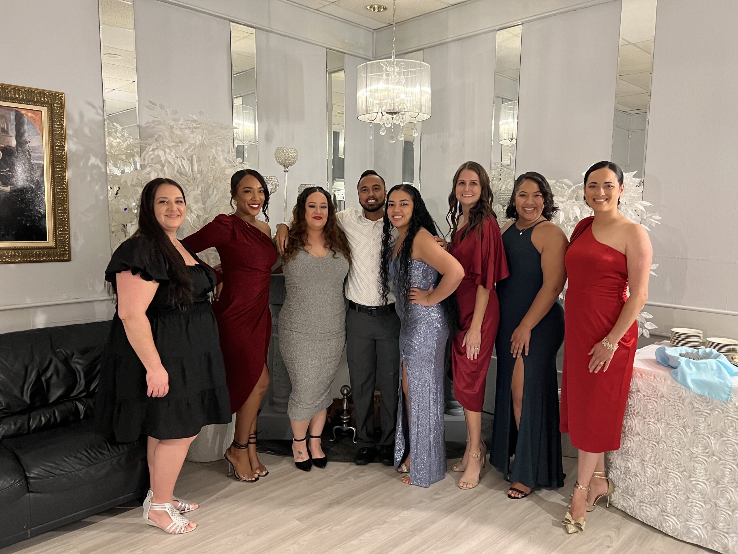 A group of people standing in front of a mirror.