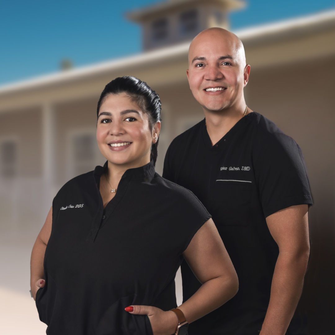 Dark Haired woman and bald man in scrubs smiling, Dr. Orta and Dr. Galvan, dentists at Smiles of Fort Myers