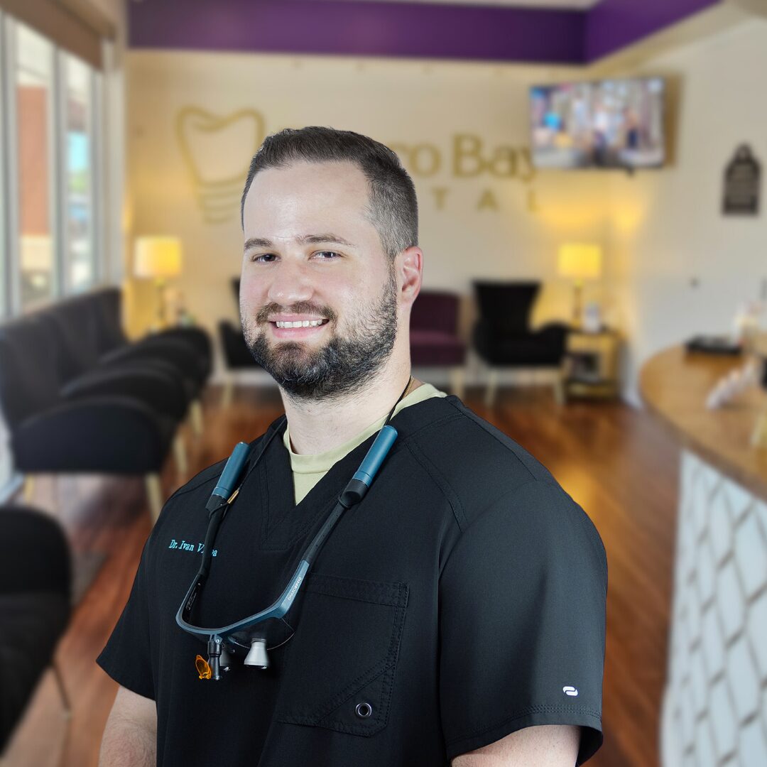 Man smiling in lobby of Estero Bay dental, Dr. Vigoa