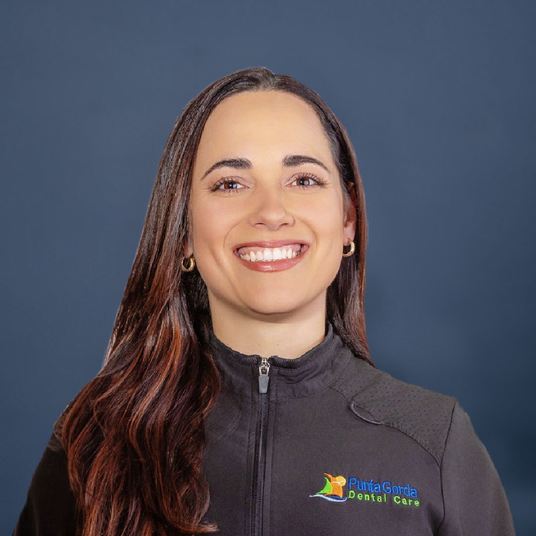 Dark haired woman in black jacket with logo, Dr. Marino of Punta Gorda Dental Care